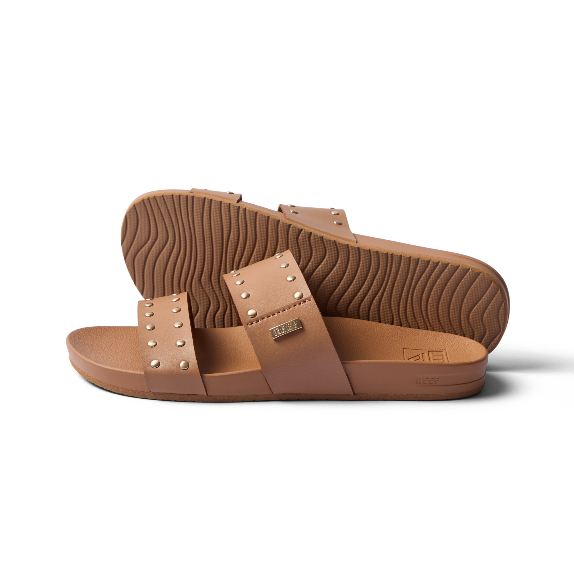 Side view of women's Cushion Vista sandals in tan with stud accents, showing soft footbed and durable outsole for beach comfort.