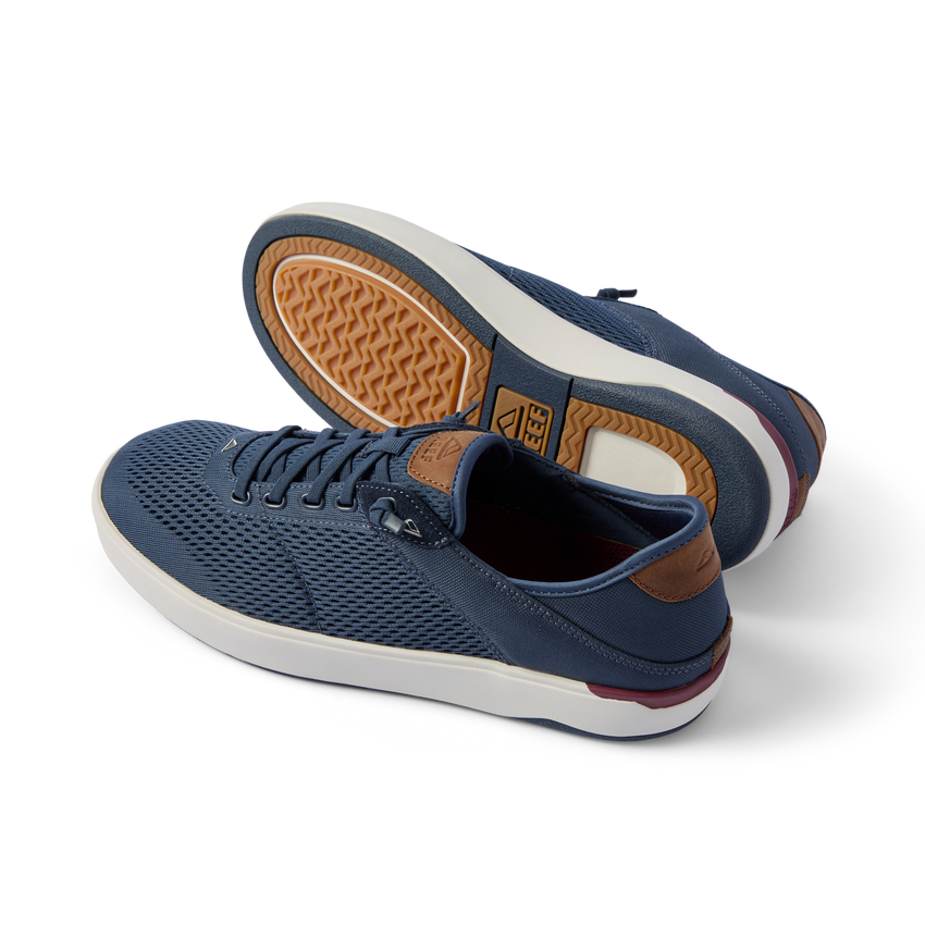 Pair of Laguna sneakers in navy with breathable mesh and rubber sole, left shoe facing left, right shoe showing sole details