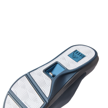 Solid Cruiser Slide men's sandals showing the navy blue and white sole facing upward with arch support detail visible