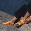 Cushion Vista sandals in tan, worn on feet facing left, showcasing lightweight, arch support beach-inspired design.