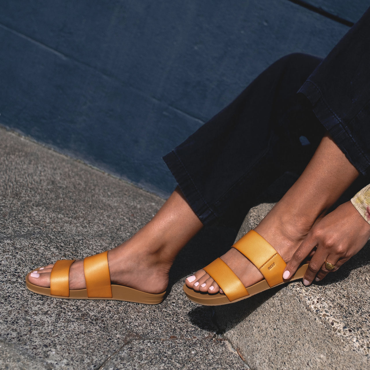 Cushion Vista sandals in tan, worn on feet facing left, showcasing lightweight, arch support beach-inspired design.