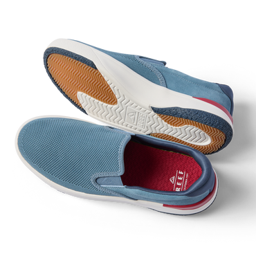 Del Mar Slip On blue slip on sneakers facing left, showing cushioned soles and easy on and off design