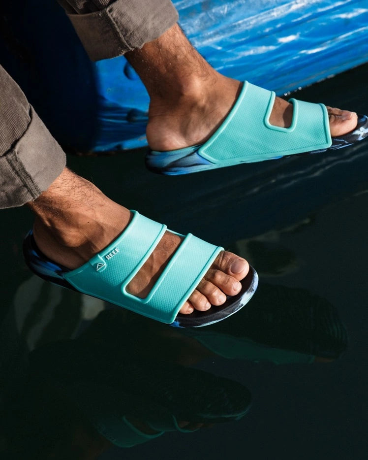 Footwear Oasis in blue dangling off boat close up