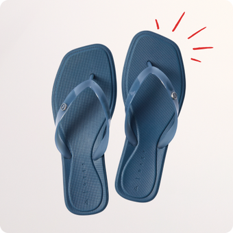 Pair of blue flip flops viewed from above with toes facing upward and red accent lines nearby