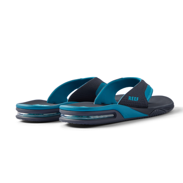 REEF Fanning water friendly flip flops facing left with cushioned footbeds and durable rubber outsoles