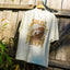 Back view of High-Stoke Relaxed Tee - Bone hanging outdoors showing surf-inspired graphic with beach lifestyle vibe