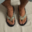 Fanning men's flip-flops showing top view of camo straps and black cushioned footbeds for beach comfort.