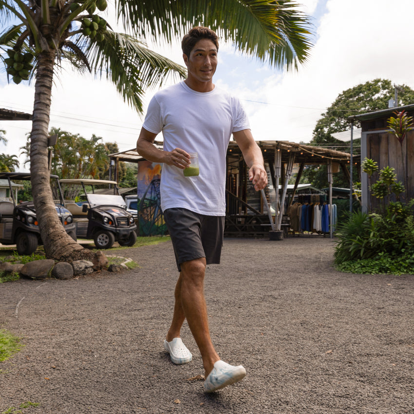 Glider white water friendly shoes facing forward on a man walking outdoors by the beach