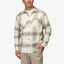 Man wearing Houston Flannel Shirt in almond with plaid pattern, front view, hands in pockets, beach-inspired casual apparel.