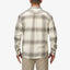 Back view of a man wearing a cream and gray Houston Flannel Shirt, showcasing the shirt’s relaxed fit and plaid pattern.