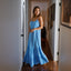 Woman wearing a light blue Lainey Maxi Dress standing in a hallway, showcasing its flowing beach-inspired design.