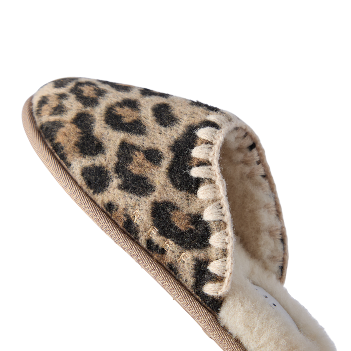 Iryss Slipper close up showing leopard print upper and plush lining with toe facing upper left