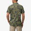 Man wearing a back view of the Kantis Shirt in moss green tropical print, surf-inspired comfort apparel for men.