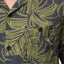 Close-up of the chest pocket on the Kantis Shirt, featuring green leaf pattern on textured dark fabric, surf-inspired comfort apparel.