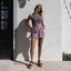 Woman wearing Vista Higher Raya sandals facing forward, styled with casual summer shorts and sleeveless top, beach-inspired comfort.