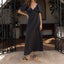 Woman wearing a black dress and Vista Carmen sandals facing right, showcasing lightweight, comfortable, beach-inspired footwear.