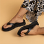 Vista Luxe Vivianahh black sandals on right foot facing forward and left foot showing sole, comfort-focused beach footwear for women.