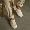 Laguna white sneakers facing forward on a seated person with breathable uppers and cushioned soles