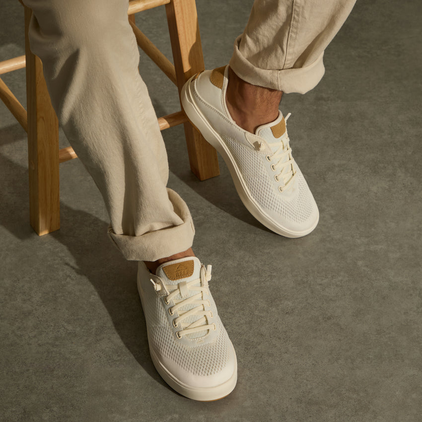 Laguna white sneakers facing forward on a seated person with breathable uppers and cushioned soles