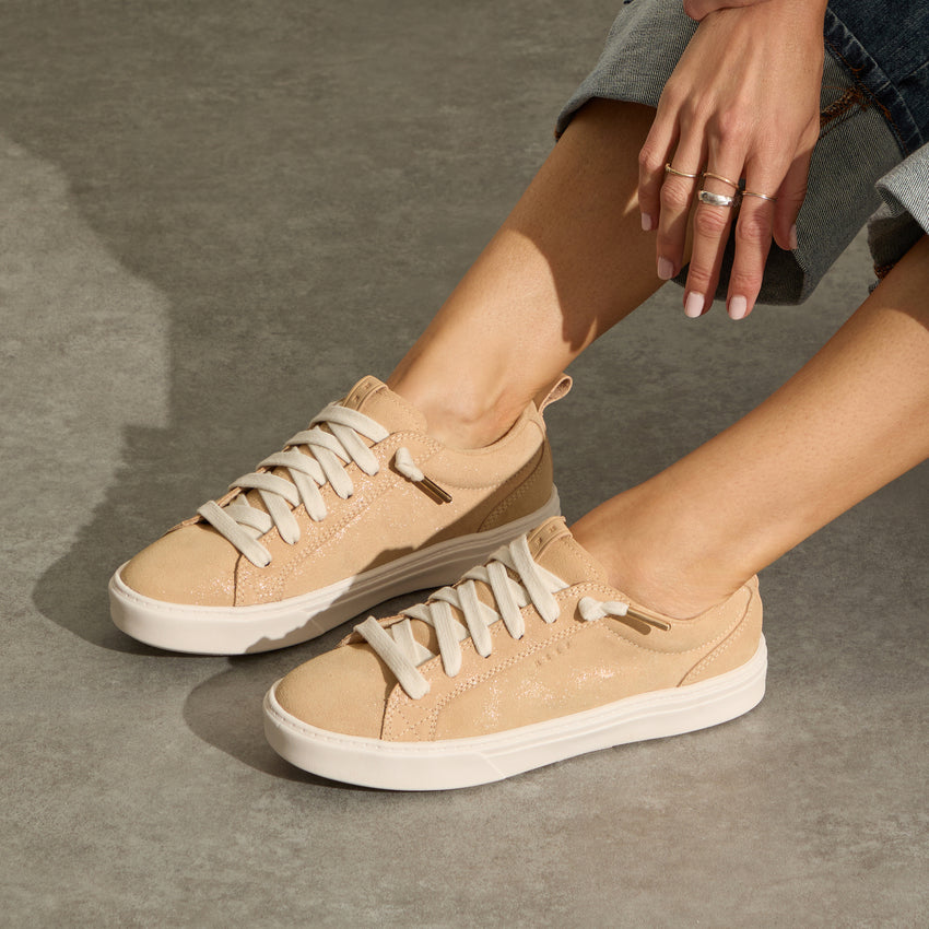 Lay Day Lite beige leather sneakers facing left with cushioned arch support for everyday comfort