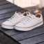 Lay Day Lite white REEF sneakers facing lower left on a wooden surface with cushioned comfort and arch support
