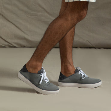 Man wearing grey Neptune Lido sneakers facing left, showing side and top views, highlighting extra cushioning and arch support.