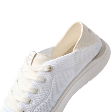 Neptune 2 white sneaker facing lower left in close up showing textured upper laces and cushioned sole