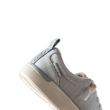 Close-up of the left side of Neptune Alana sneaker in blue textile, showing arch support and cushioned sole.