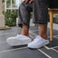 White Neptune HT shoes facing right, side and sole visible, beach-inspired with arch support and soft cushioning.