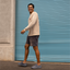 Man walking to the left wearing Neptune shoes, showcasing the side and top with comfort-focused design and beach-inspired style.