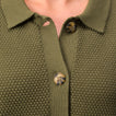 Close-up of the button and textured fabric front of the olive green Up North Sweater Top for women.