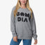 Woman wearing grey Oversized Raglan Fleece with black graphic text, front view, highlighting comfort and casual style.