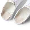 Top-down close-up of the heel area of the white Neptune HT sneaker showing cushioned footbed and arch support.