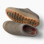 Pair of gray slip-on shoes facing left, one showing its textured outsole and the other showing its cushioned footbed