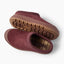 Burgundy slip-on shoes facing left, showing a rugged outsole and plaid-lined footbed with cushioned comfort