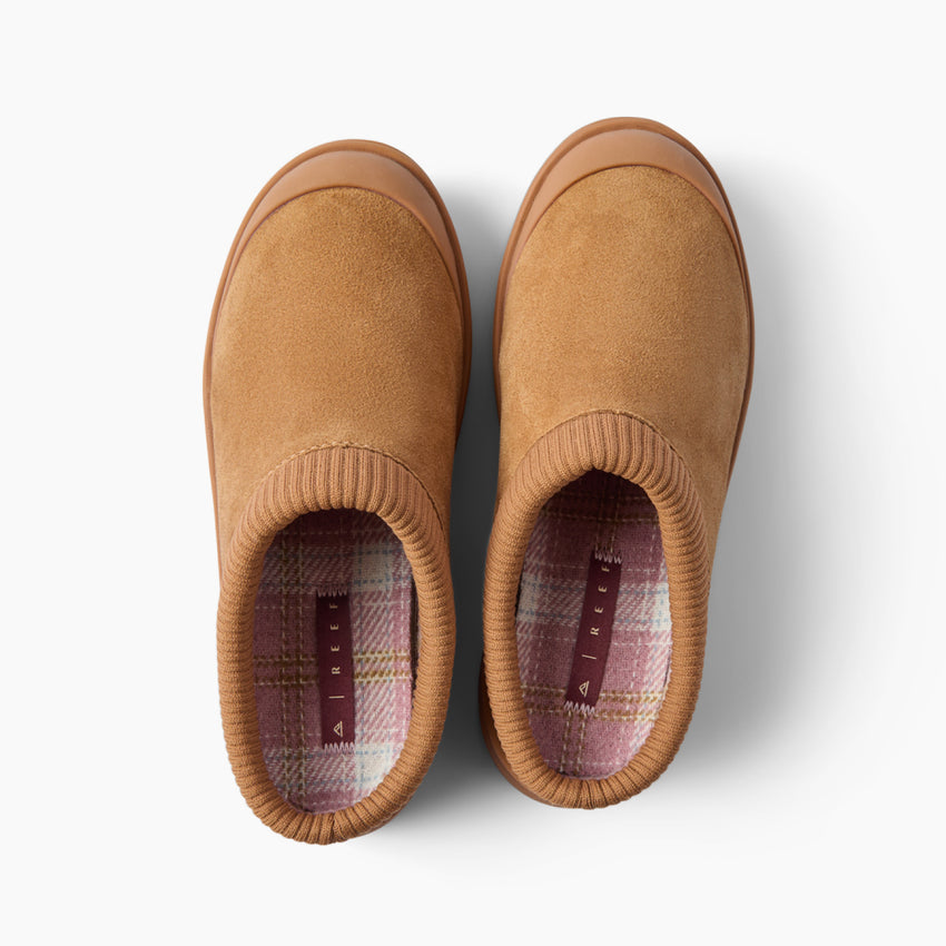 Top view of brown slip on shoes facing upward, with ribbed openings and plaid insoles