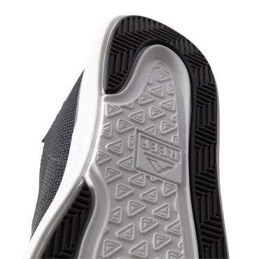 Close-up of the black Neptune HT shoe sole facing upward, showing durable, water-friendly tread with REEF comfort technology.