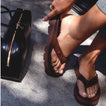 Close-up of a left foot wearing a brown Vista Luxe Vivianahh flip flop facing forward, showcasing comfort and arch support.