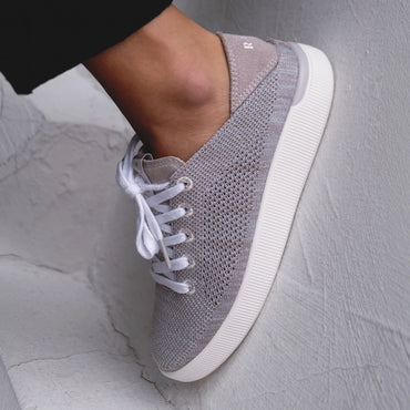 Reef Neptune shoe facing right, close-up of breathable stretch knit upper with laces and cushioned sole.