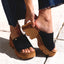 Vista Luxe Evie showing right foot sliding into black suede mule facing left with thick platform sole, soft cushioning design.