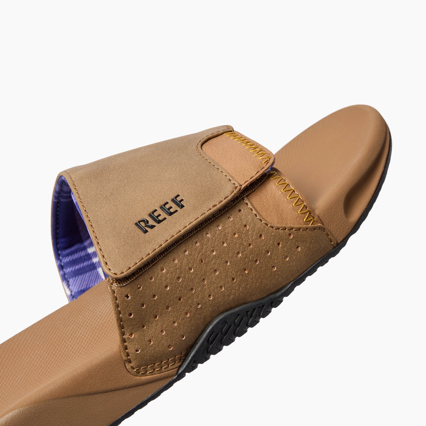 Fanning Slide tan sandal facing upper right, close-up of cushioned footbed and adjustable strap