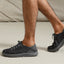 Neptune HT facing right on feet, men's black sneaker with lightweight knit upper, shaped sole, and arch support for comfort.