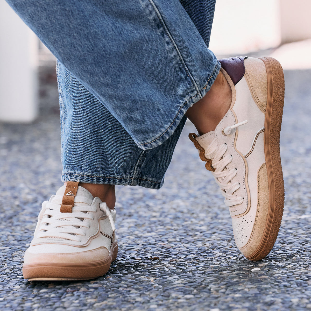 Kickback sneakers with one shoe facing right and one facing forward in a lightweight comfort street style setup