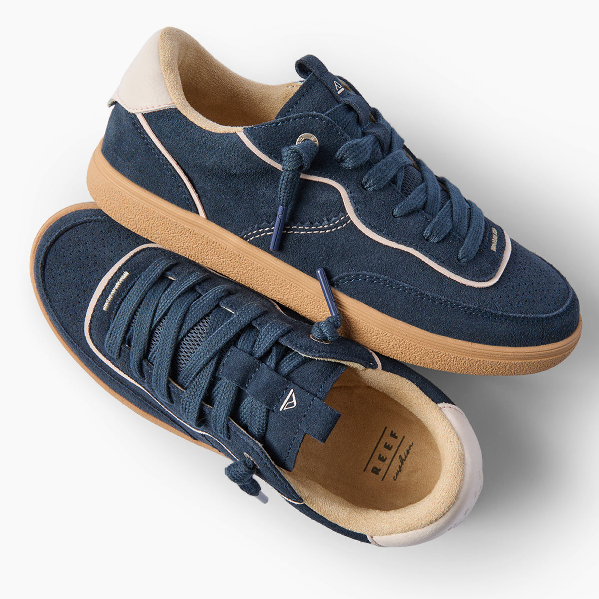 Kickback navy sneakers, one facing right and one angled toward the viewer, with cushioned soles