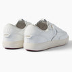 Kickback white sneakers viewed from the rear three quarter angle with toes facing right