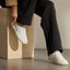 Kickback white sneakers facing right, worn for everyday comfort with lightweight cushioning and supportive design