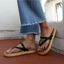 Vista Carmen women's sandals facing right showing the top and side with black straps, cushioned sole, beach-inspired design.