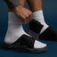 Close-up of a left-foot Cruiser Slide sandal facing right with adjustable strap, showing surf-inspired comfort features.