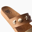 Cushion Vista women's tan sandal facing left, close-up of the front strap with seashell embellishments, beach-inspired comfort.