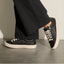 Lay Day Lite black sneakers facing left with cushioned soles and lace up styling for everyday comfort